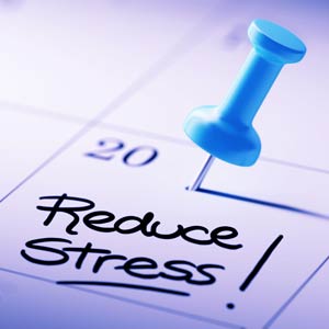 Push pin in the 20th calendar day of the month with the words “Reduce Stress!” in black in the same box