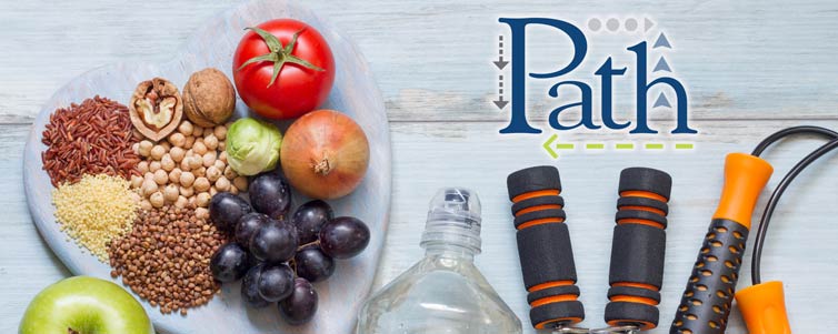 A plate of grains, nuts, fruits and vegetables on a heart plate on the left and a water bottle, hand grip and a jump rope on the right.