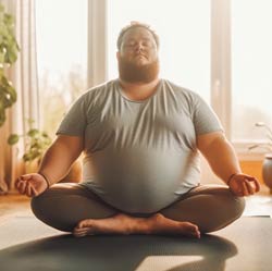 Young man sitting in a zen yoga pose.