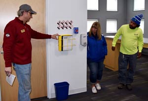 Paul talking with two employees about an agency safety feature.