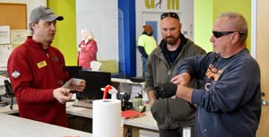 Paul meeting with two other employees in a break room.