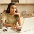 Young female participating in training class on laptop.