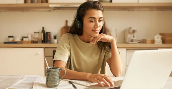 Young female participating in training class on laptop.