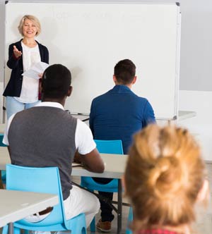 Classroom with female instructor at front.